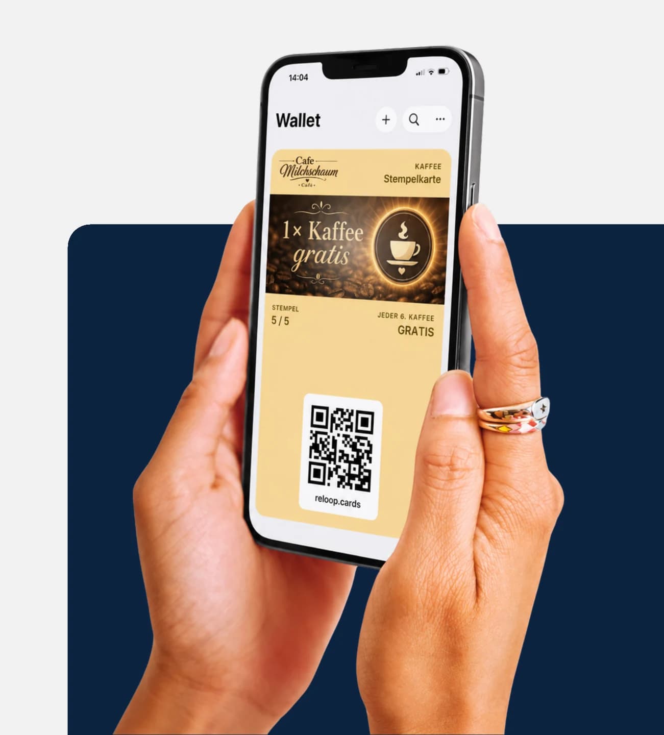 Hand hält ein iPhone mit geöffneter Apple-Wallet-App; darin liegt die digitale Bonuskarte des fiktiven Demo-Betriebs Cafe Milchschaum mit 5 von 5 Stempeln und der freigeschalteten Belohnung „1× Kaffee gratis“.